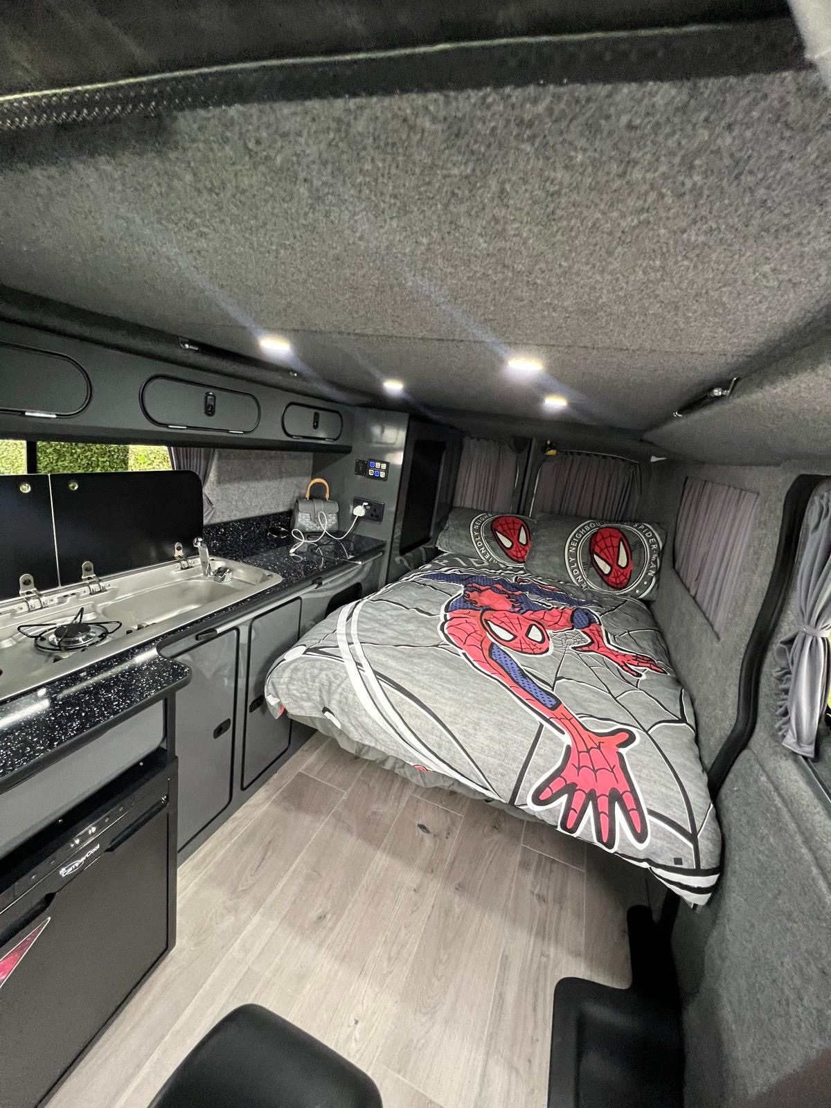 Inside a JMC campervan, with the bed made up